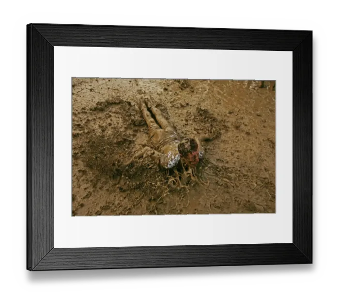 Framed Print : A music fan slides in the mud, at the Glastonbury music festival, Pilton, Somerset 22 June 2007 Framed Print : A music fan slides in the mud, at the Glastonbury music festival, Pilton, Somerset 22 June 2007