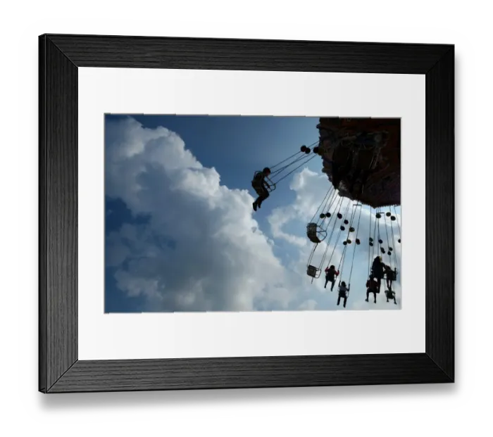 Framed Print : People sit on a merry-go-round at the annual funfair Cranger Kirmes in Herne Framed Print : People sit on a merry-go-round at the annual funfair Cranger Kirmes in Herne