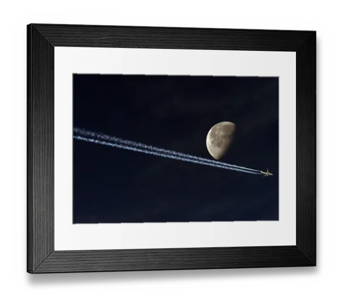 Framed Print : Jetliner Vapour Trail Passing the Moon