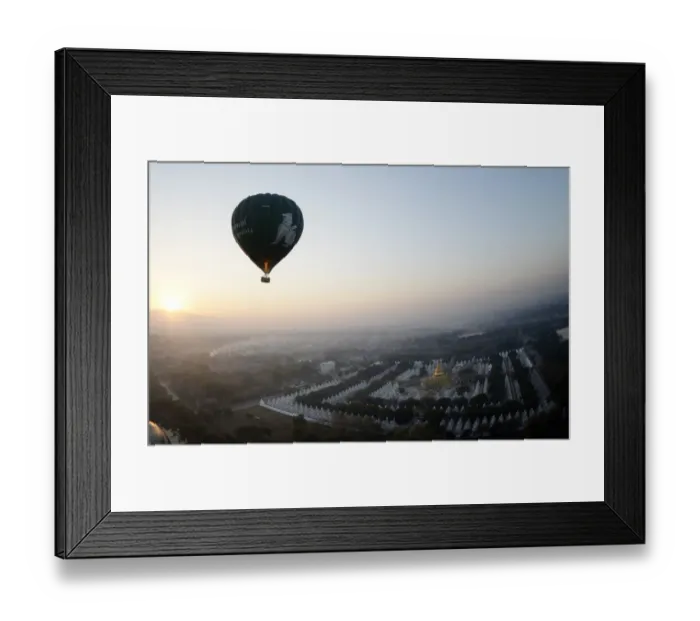 Framed Print : This photo taken on February 5, 2014 shows a hot air balloon flying over a temple