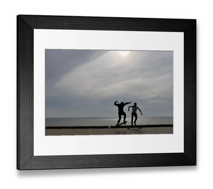 Framed Print : People ride a skateboard along the beach on October 7, 2016 in Saint-Nazaire, western France Framed Print : People ride a skateboard along the beach on October 7, 2016 in Saint-Nazaire, western France