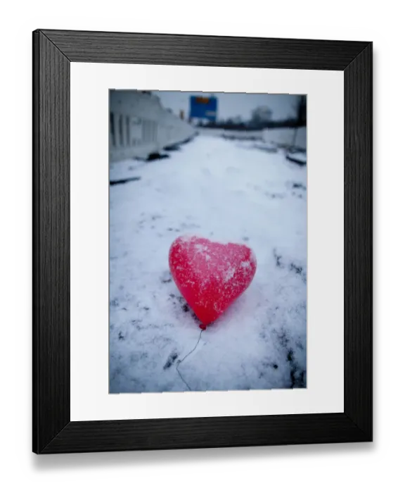 Framed Print : A red heart-shaped balloon lays in the snow on Februray 14, 2012 in Frankfurt  /  M. western Germany