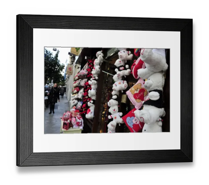 Framed Print : A woman walks past a shop selling love themed toys ahead of Valentine s Framed Print : A woman walks past a shop selling love themed toys ahead of Valentine s
