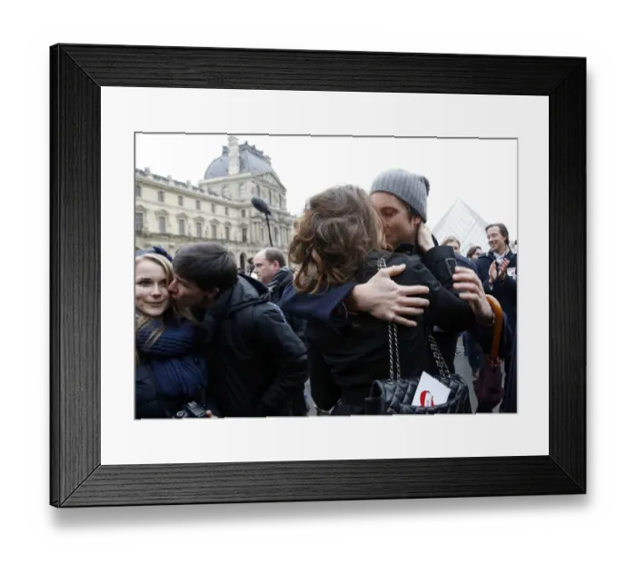Framed Print : A couple kisses during a flashmob near the Louvre Pyramid in Paris on February 14