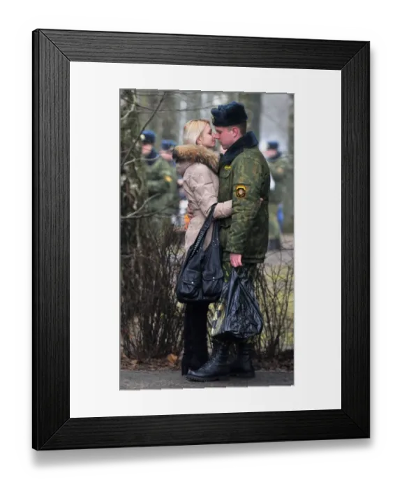 Framed Print : A Belarus soldier shares a tender moment with his sweetheart during their meeting