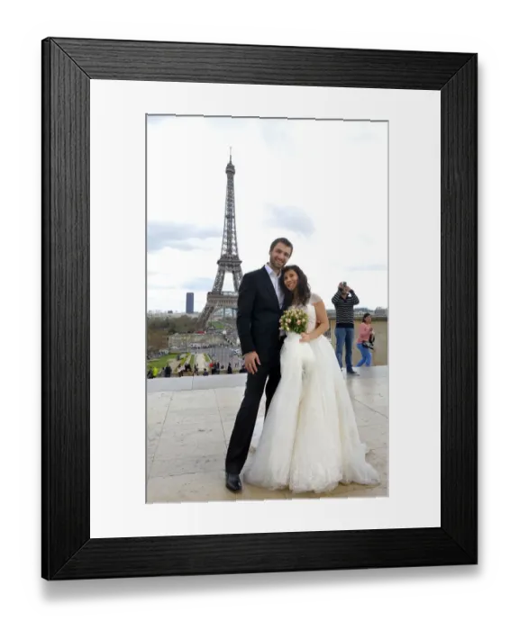 Framed Print : A mixed American and Roumanian newly married couple poses in front of the Eiffel tower on March 21 Framed Print : A mixed American and Roumanian newly married couple poses in front of the Eiffel tower on March 21