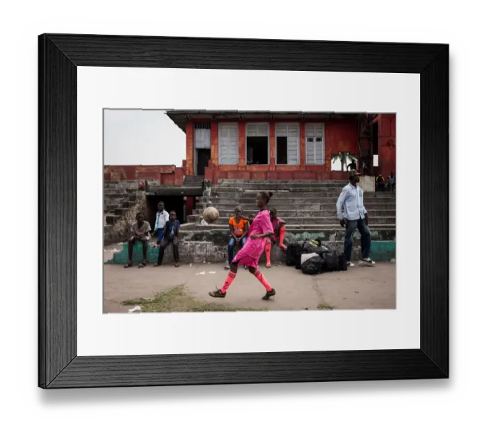 Framed Print : A player juggles before a match in Kinshasa on April 11, 2015. AFP PHOTO / FEDERICO SCOPPA Framed Print : A player juggles before a match in Kinshasa on April 11, 2015. AFP PHOTO / FEDERICO SCOPPA