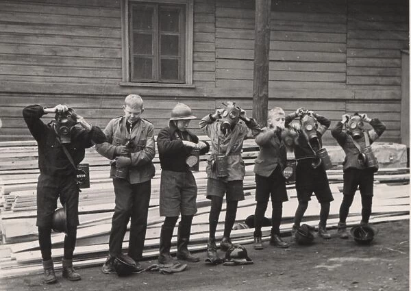 Finnish boy scouts trying on gas masks, WW2