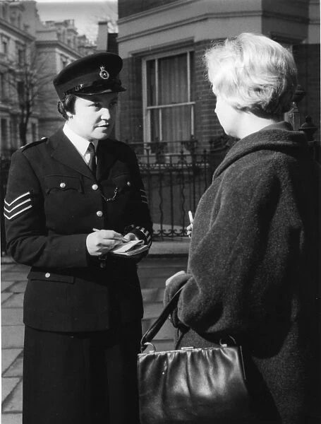 Woman police officer and woman with handbag