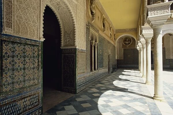 Arcade of the Patio Principal showing Mudejar carving and tilework