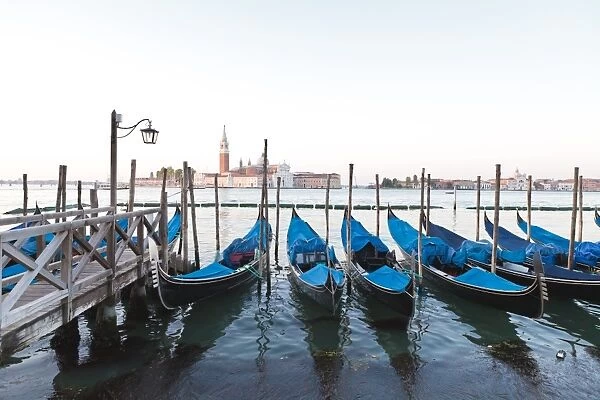 Gondolas moored on the Lagoon, San Giorgio Maggiore beyond, Riva degli Schiavoni