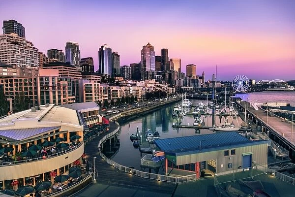 Sunset over Bell Harbor Marina on the Seattle Waterfront with citys skyline in the background