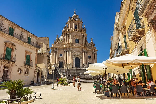 Ragusa Ibla, Sicily. Tourists walking and sitting in the restaurants in the main square