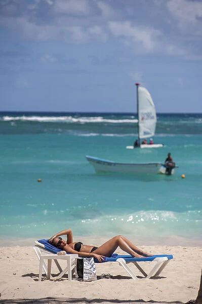 Dominican Republic, Punta Cana, Higuey, Bavaro, Bavaro Beach, young woman sunbathing