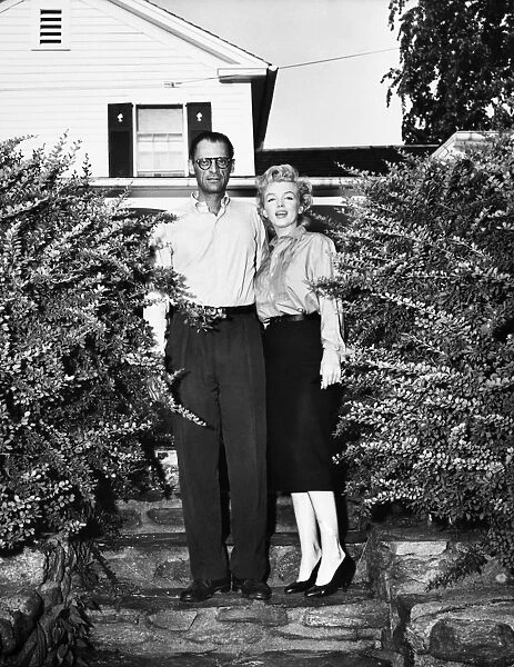 MILLER & MONROE, 1956. American playwright Arthur Miller and movie star Marilyn Monroe, photographed in front of Millers summer house at Roxbury, Connecticut, shortly before their wedding, June 1956