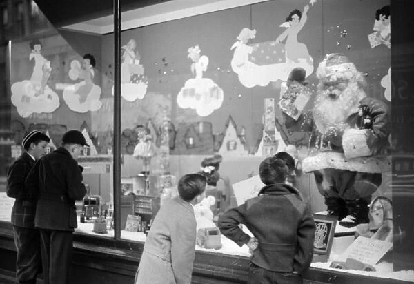 WINDOW SHOPPING, 1940. Window shoppers looking at toys in the window display of