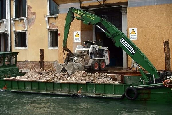 Barge with rubble on canal, Venice, Italy