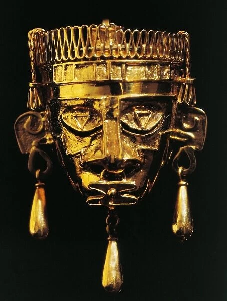 Gold mask of God Xipe Totec (Our Lord the Flayed One) from tomb no 7 at the Monte Alban archaeological site, Mexico