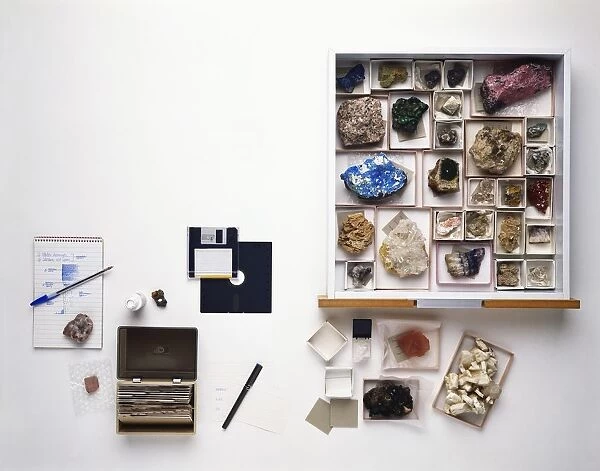 Rock collection with notepad, pen, card index box, correction fluid, index cards, drawer containing boxes of rocks, specimen labels