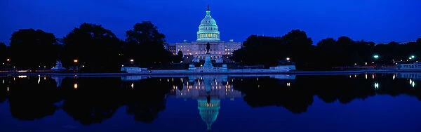 This is the U. S. Capitol set in front of the Capitol reflecting pool at sunset. The image of the U. S. Capitol is reflected in the reflecting pool
