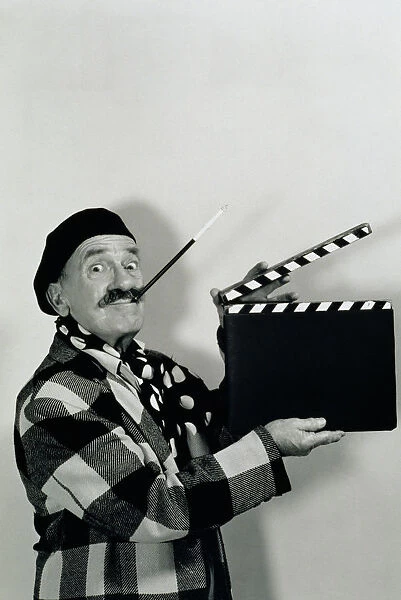 FILM DIRECTOR HOLDING CLAPBOARD