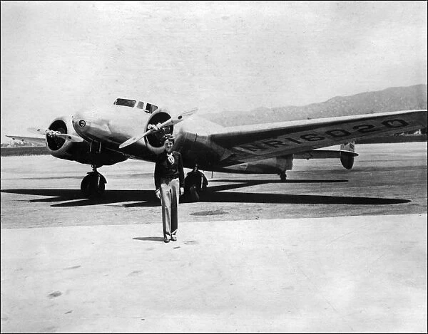 Amelia Earhart in front of her plane
