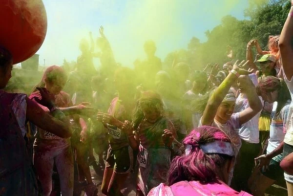 Australia-Color-Run. Participants throw powder over each other during a