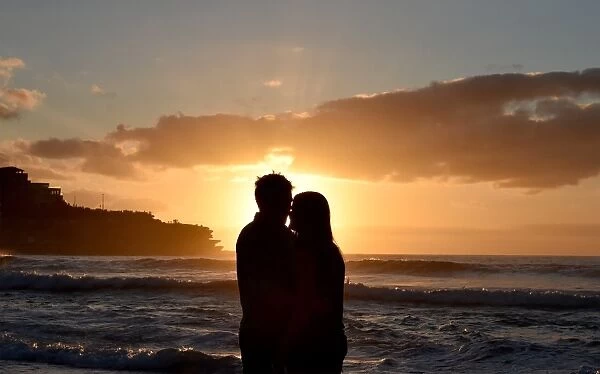 Australia-New-Year. A couple kisses to celebrate New Year 2016 at the sunrise