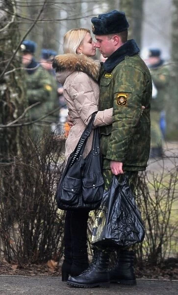 A Belarus soldier shares a tender moment with his sweetheart during their meeting