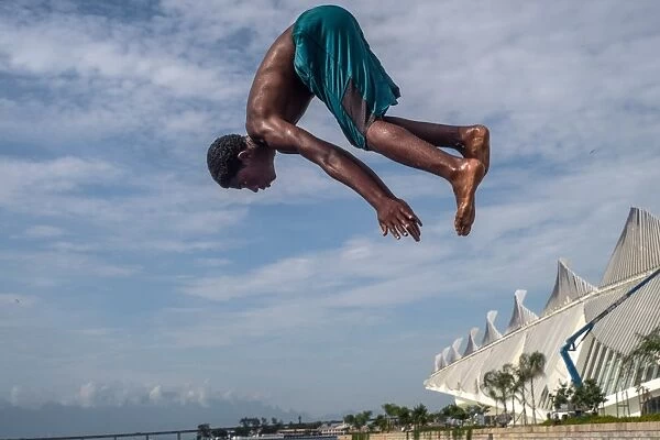 Brazil-Rio-Feature. A boy jumps into the water in Rio de Janeiro, Brazil. AFP PHOTO
