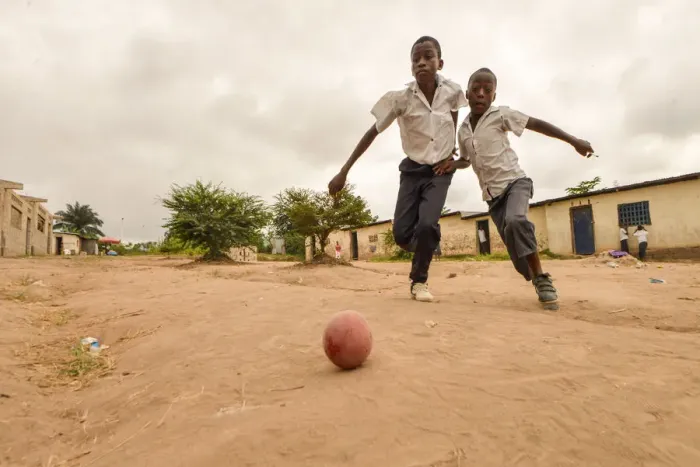 Framed Print : Children play football in the streets of the Kinsuka neighbourhood in the city of