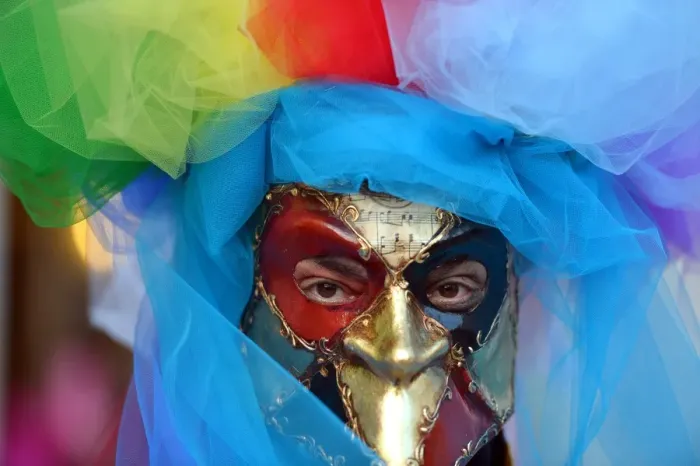 Framed Print : A costumed reveller poses near Saint Marks square during the carnival on February 21