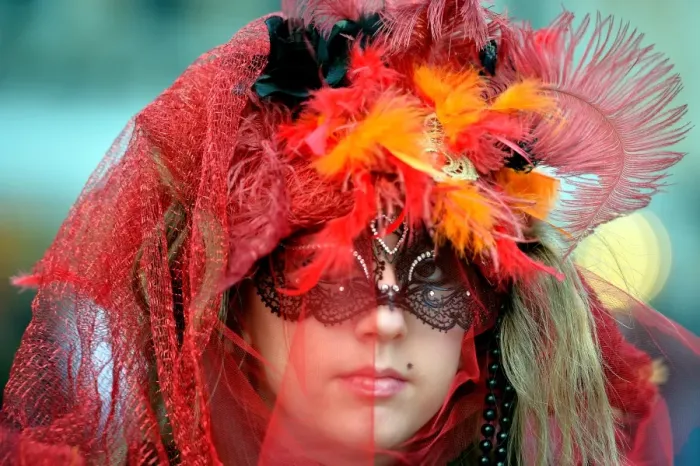 Framed Print : A costumed reveller poses near Saint Marks square during the carnival on February 21