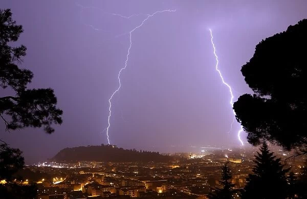 A flash of lighting lights up the sky above the Baie des Anges in Nice