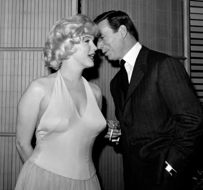 Framed Print : French Actor and Singer Yves Montand Whispers to Marilyn Monroe