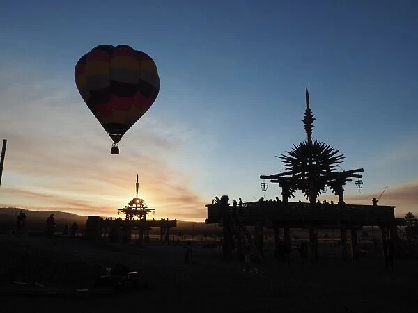 Hot air balloon flies over the Solar Temple at dawn at the Symbiosis Oregon Eclipse Festival