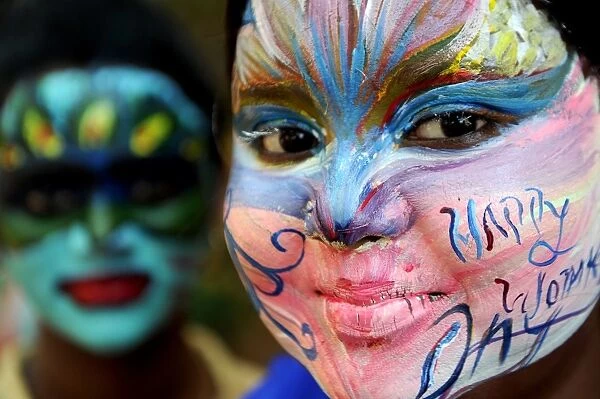 India-Society-Women. Indian students pose with their faces painted at a