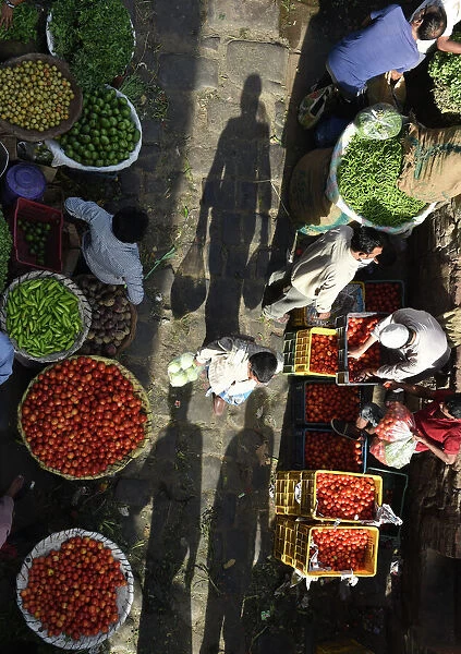 India-Travel-Market. Indian customers shop at a wholesale vegetable market