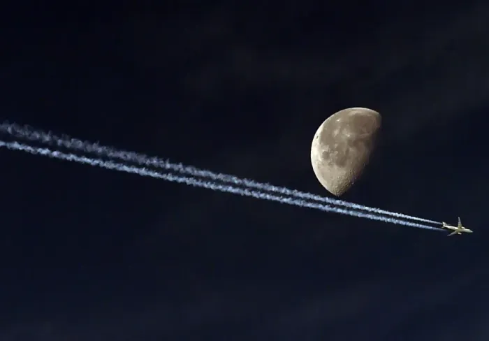 Framed Print : Jetliner Vapour Trail Passing the Moon