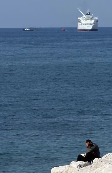 Lebanon-Theme-Love. A Lebanese couple embrace as they sit on the seaside