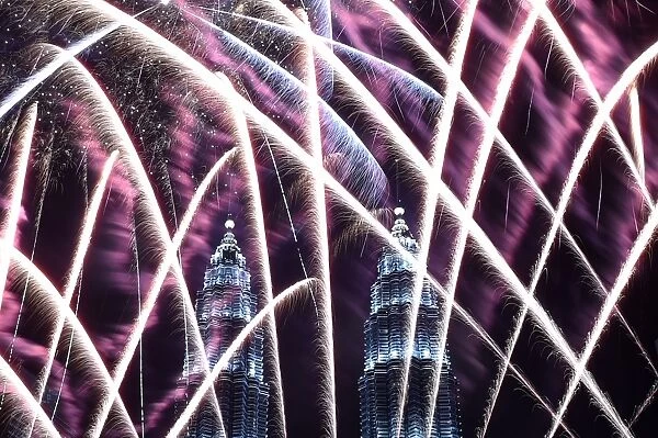 Malaysia-New-Year. Fireworks illuminate the sky near Malaysia's Petronas