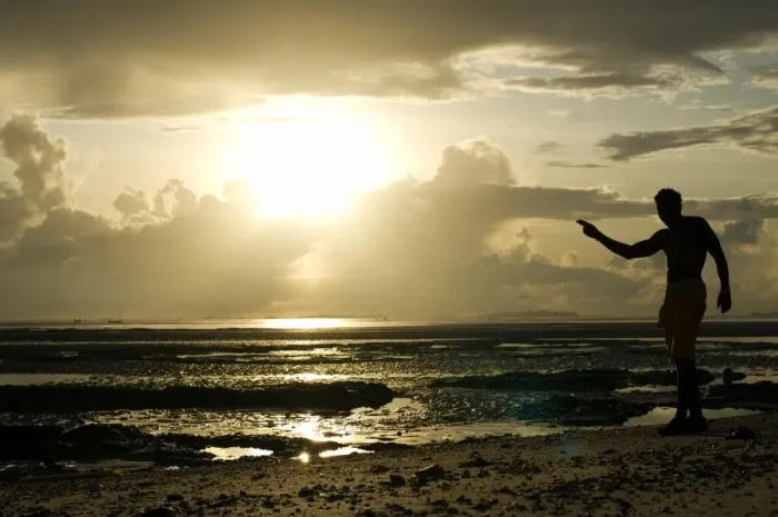Framed Print : A man gestures on a beach in Dar es Salaam on April 26, 2014, as Tanzania celebrates Framed Print : A man gestures on a beach in Dar es Salaam on April 26, 2014, as Tanzania celebrates