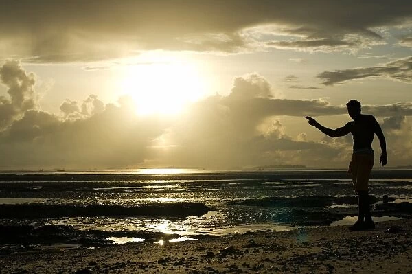 A man gestures on a beach in Dar es Salaam on April 26, 2014, as Tanzania celebrates