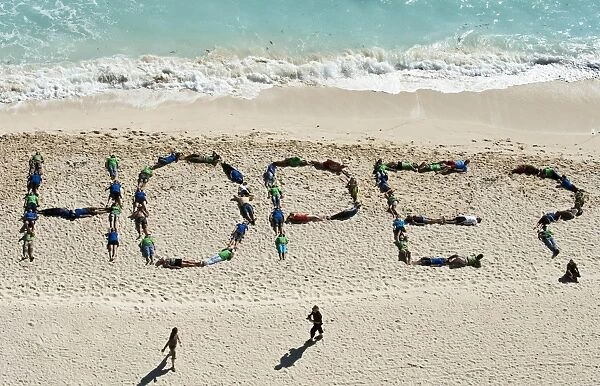 Mexico-Beach-Hope. Members of Greenpeace and Tcktcktck make a sign in the