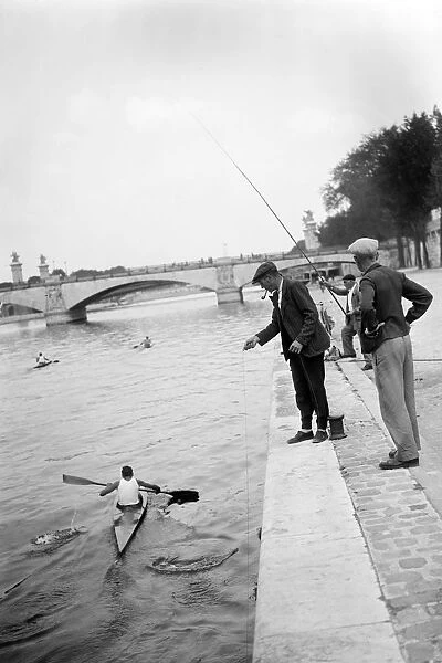 PARIS-SEINE-SUMMER. Men fish in the Seine river near the Pont d'Ina in