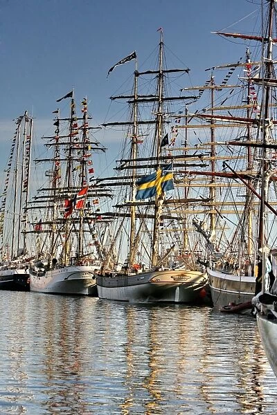 People look at ships docked at the Lithuanian Baltic Sea port of Klaipeda on August 2