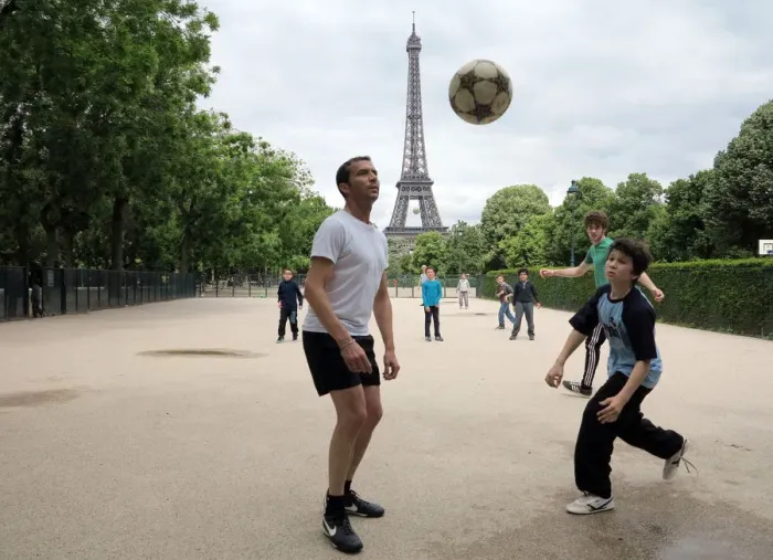 Framed Print : People play football on May 29, 2014 in front of the Eiffel tower, in Paris Framed Print : People play football on May 29, 2014 in front of the Eiffel tower, in Paris