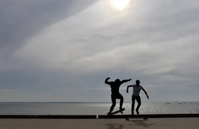 Framed Print : People ride a skateboard along the beach on October 7, 2016 in Saint-Nazaire, western France Framed Print : People ride a skateboard along the beach on October 7, 2016 in Saint-Nazaire, western France