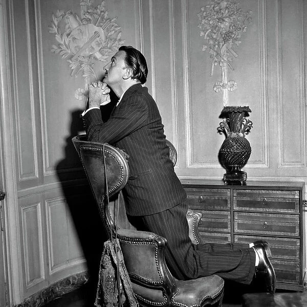 Salvador Dali Poses in front of one his paintings