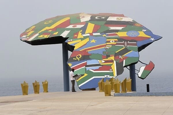 Senegal-Africa-Map. A man reads his newspaper in front a map of Africa